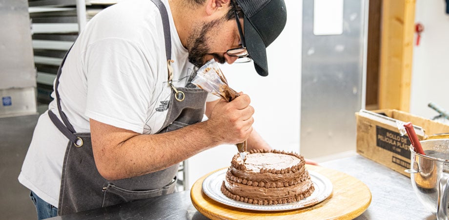 Man decorating a cake