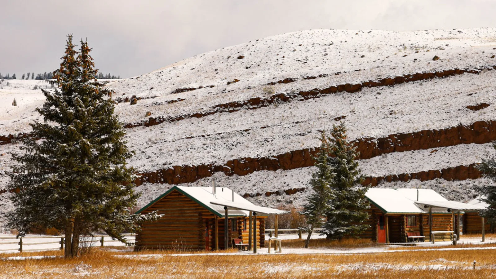 A snowy mountain with houses and a ski lift