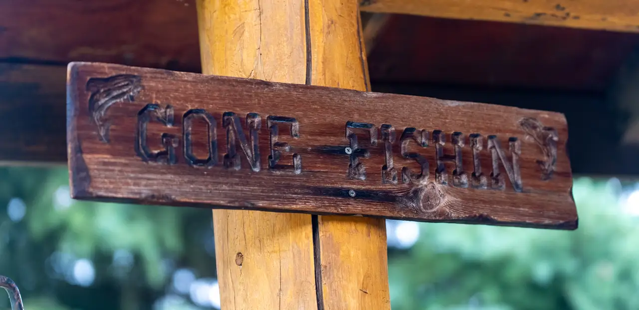 A wooden sign that says 'Gone Fishing' on it