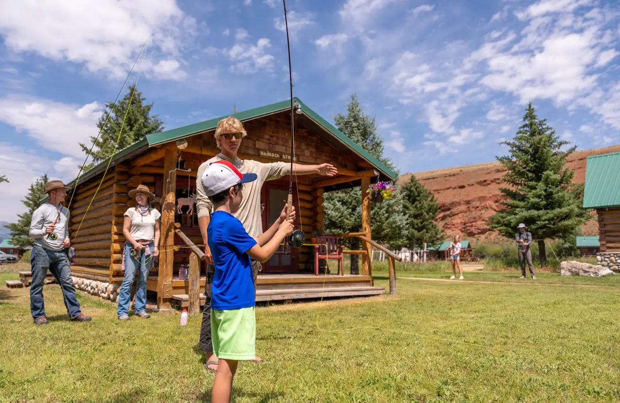 A man and a boy are flying a kite in a grassy field