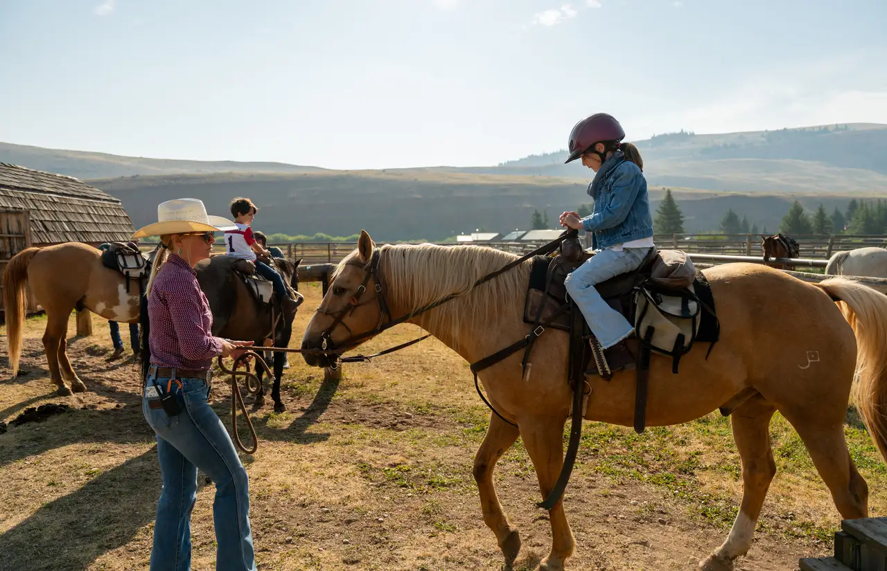 People riding horses in a field