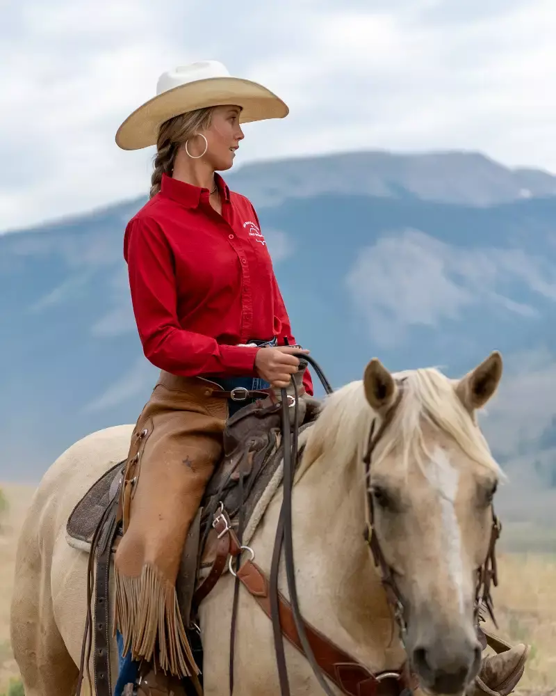 A woman riding a horse in a field