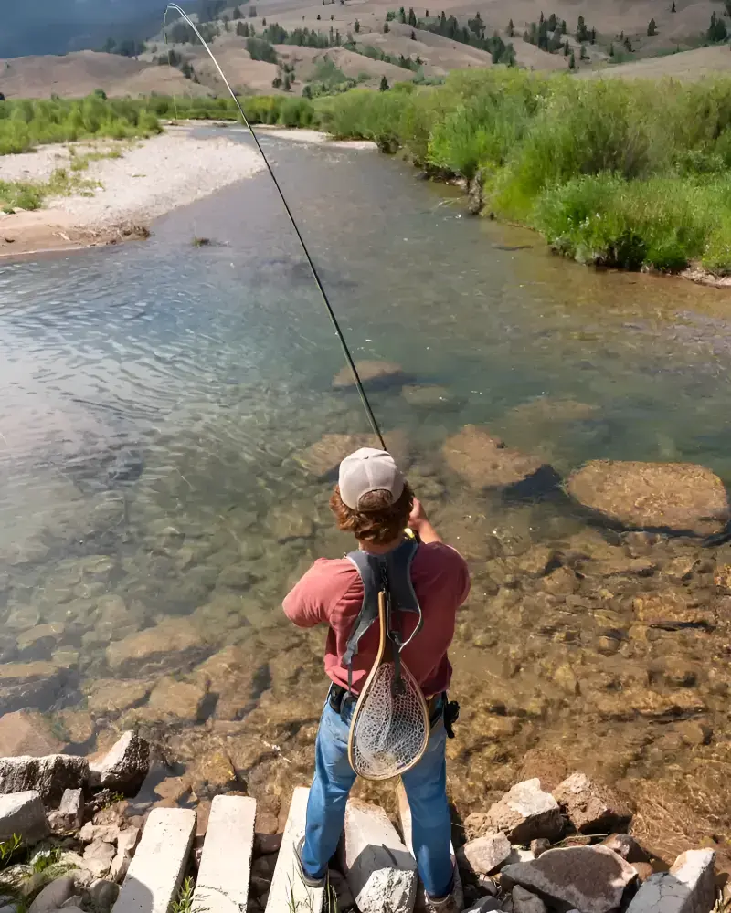 A man fishing on a bridge